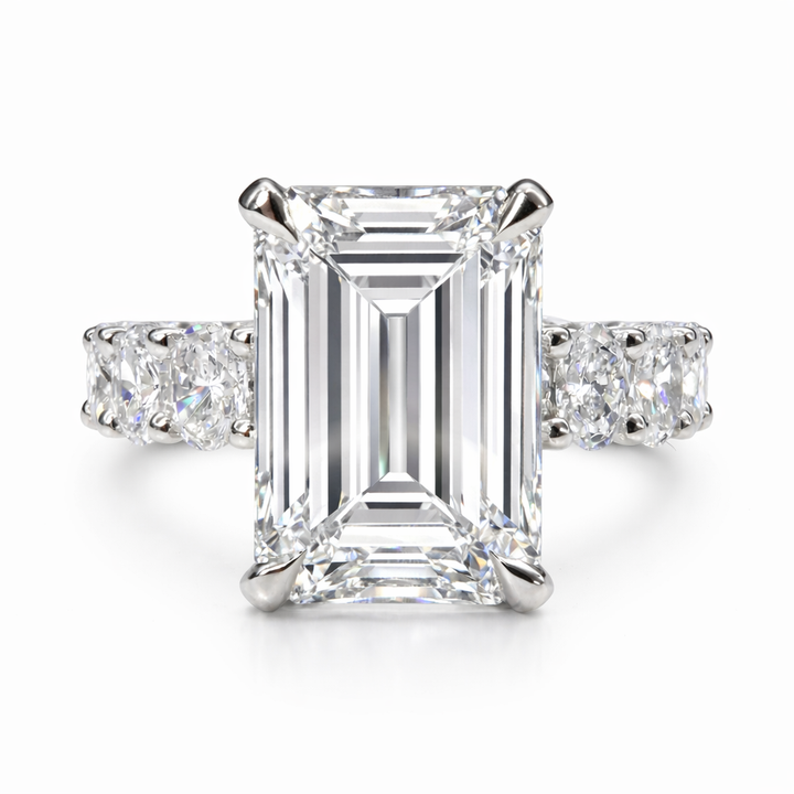 Engagement ring with a emerald-cut lab-grown center diamond in white metal, front view.