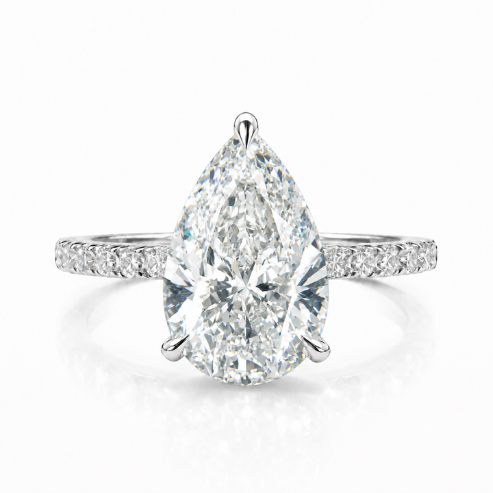 Engagement ring with a pear-shaped lab-grown center diamond in white metal, front view.