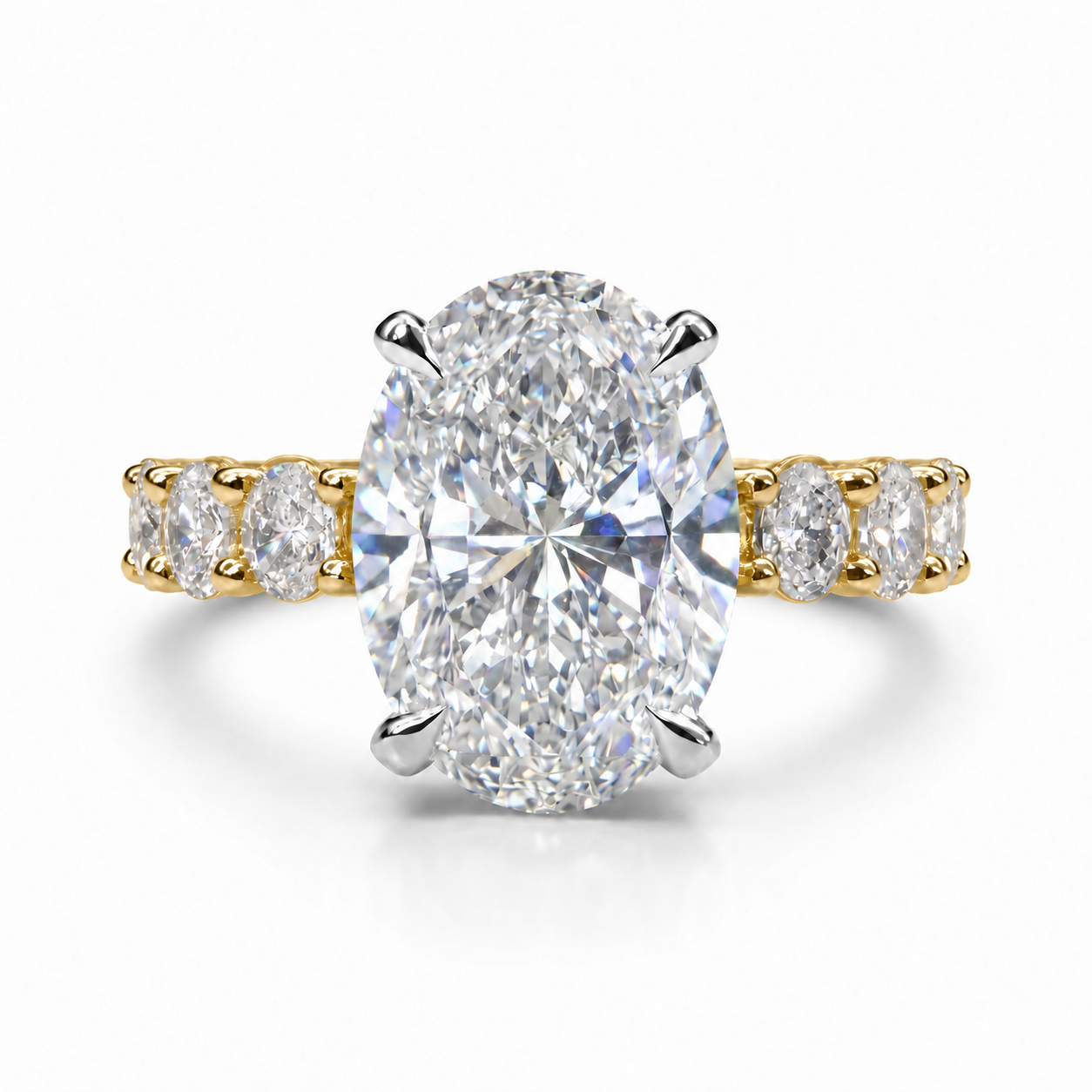 The 3MM Olivia engagement ring with an oval lab-grown center diamond in two-tone gold with white center prongs