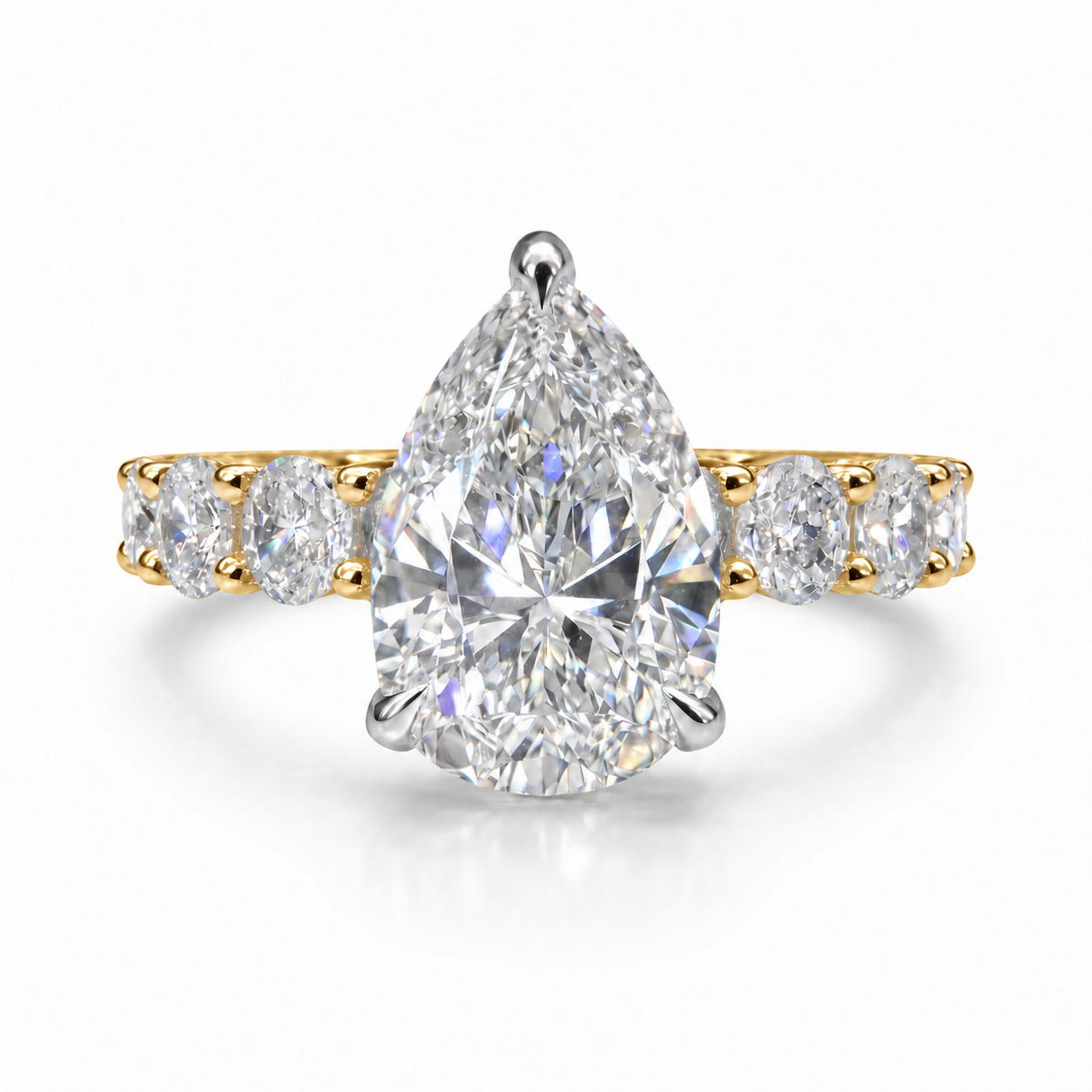 The 3MM Olivia engagement ring with a pear lab-grown center diamond in two-tone gold with white center prongs